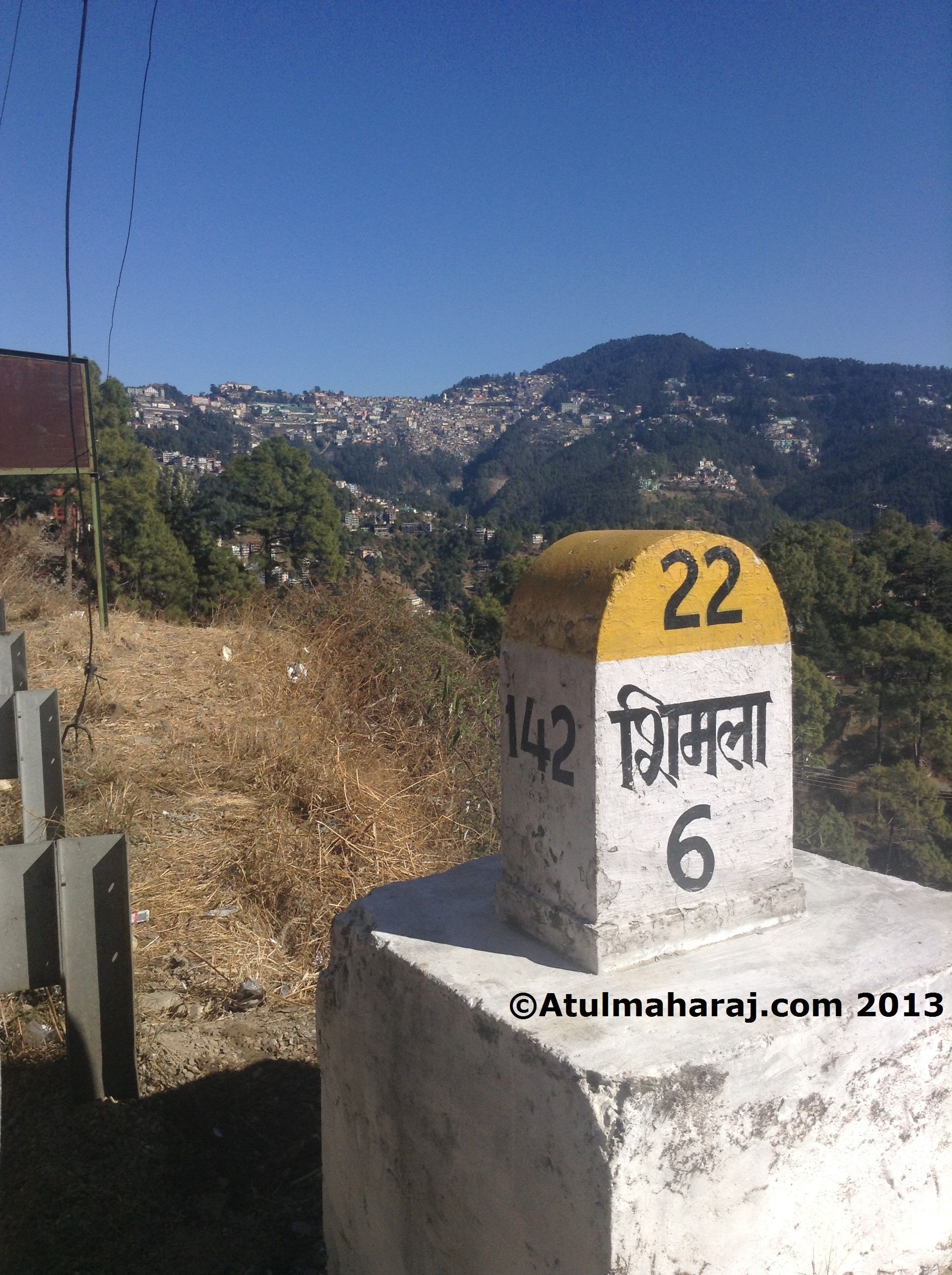 A milestone with Shimla in the backdrop on NH-22.